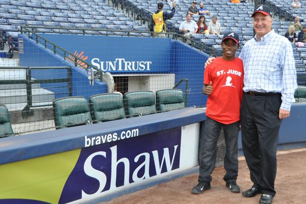 Randy Merritt, President of Shaw Industries, and St. Jude patient Archie at Atlanta Braves Game.